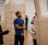 Two men looking up and smiling at a large fibre glass water vessel sculpture